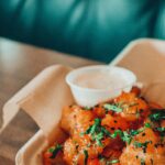 orange sauce on white ceramic bowl